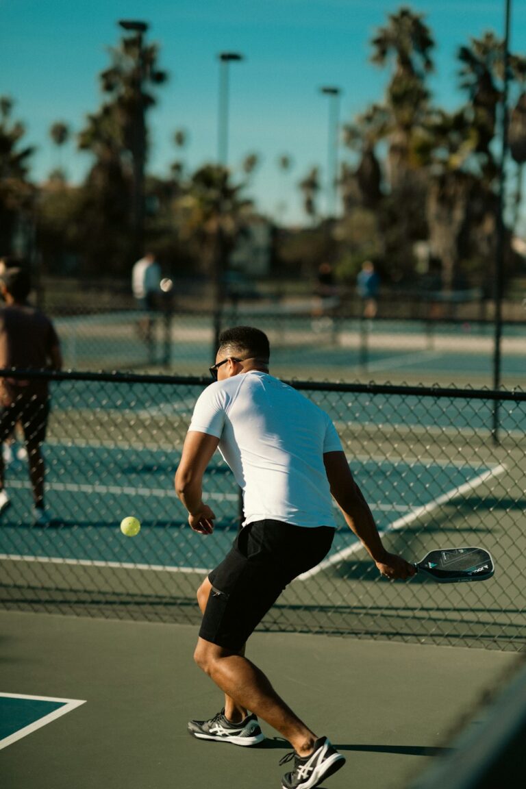 Jugador de pickleball preparando el golpe de saque con la pala baja